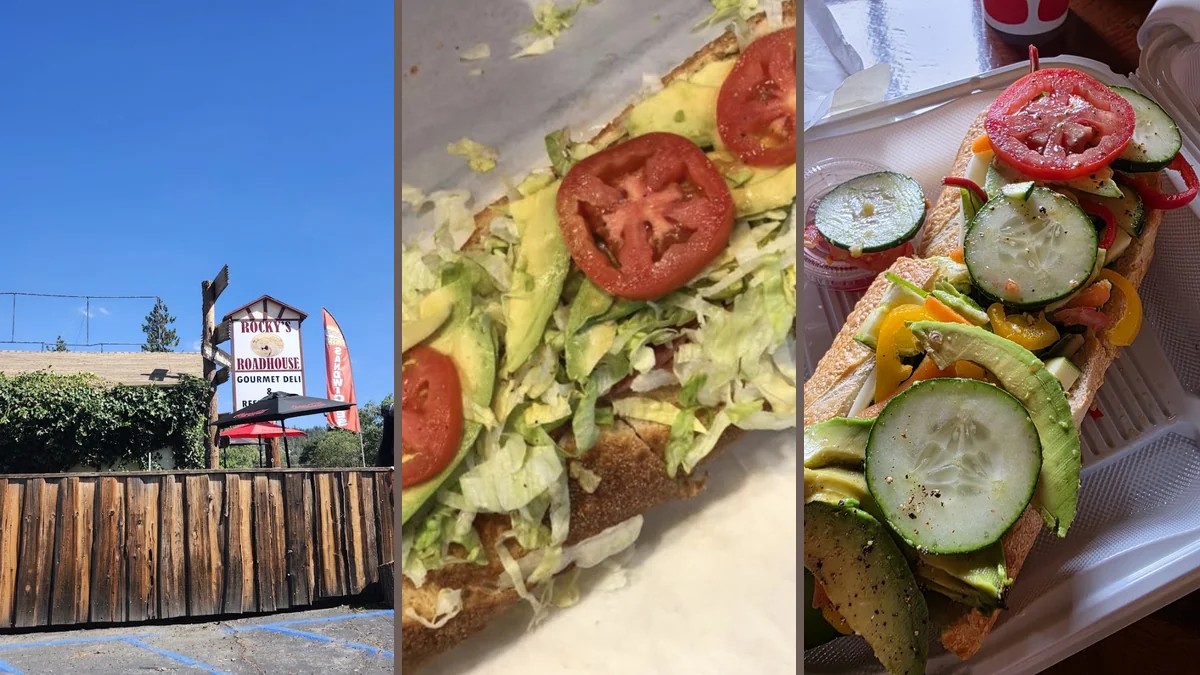 Sandwiches on a counter with sides nearby.