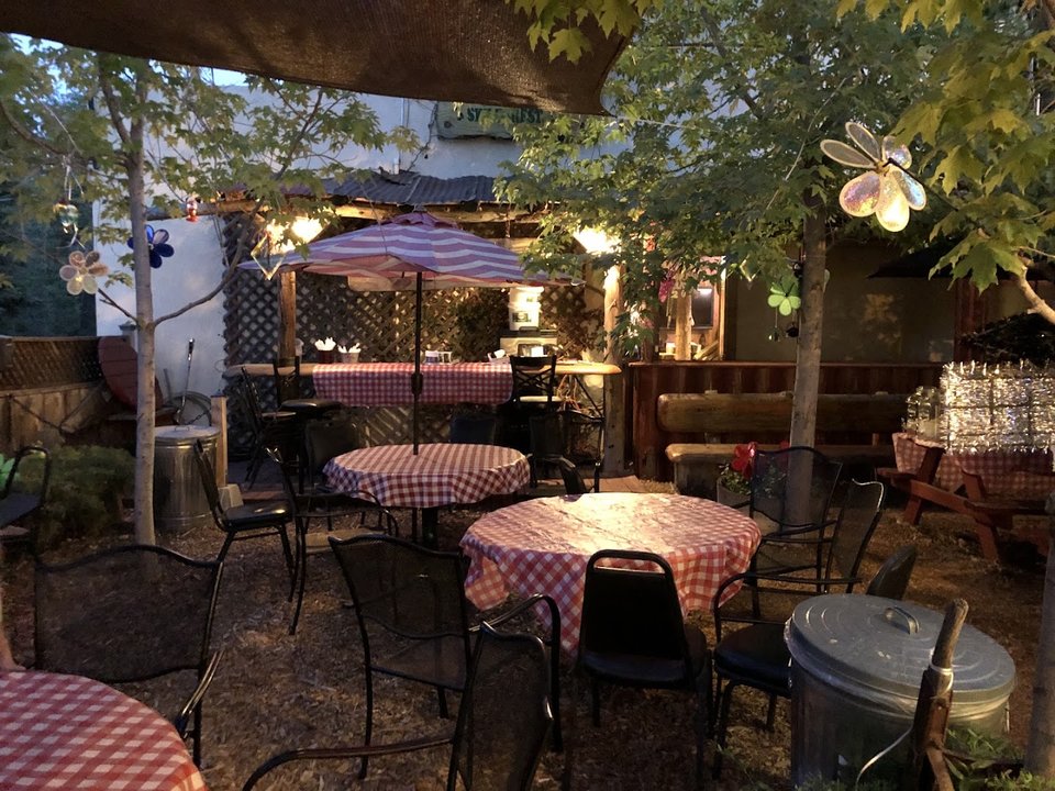 A sandwich shop with outdoor seating.