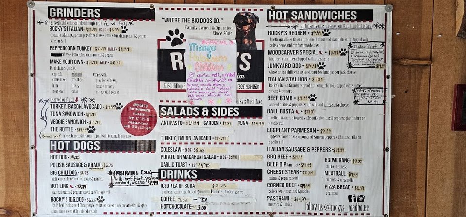 Printed menu with sandwiches and sides.
